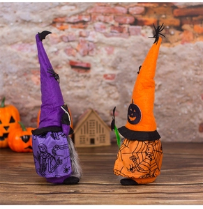 Detailed view of plush Halloween gnomes with bat and pumpkin motifs in festive setting