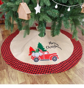 Close-up of burlap Christmas tree skirt featuring red truck gnomes and plaid border