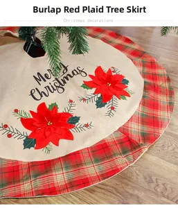 Detail of burlap Christmas tree skirt with Merry Christmas text and red poinsettia pattern
