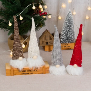 Set of four light-up plush Christmas gnomes with sequined hats and glowing warm LED lights