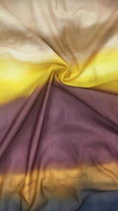 Detail of gradient mesh fabric with soft folds showing a transition from beige to deep blue