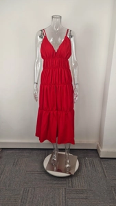 Detail of red V-neck maxi dress with smocked waist and layered tiered skirt