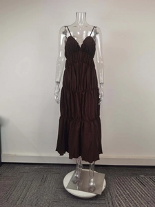 Detail of deep brown tiered maxi dress with ruched V-neck and delicate straps