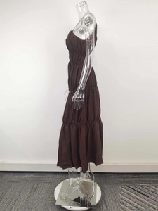 Detail view of the smocked waist and tiered skirt of the coffee brown v-neck midi dress
