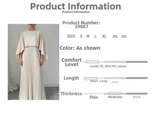 Dettaglio del completo beige a due pezzi con gonna lunga a pieghe e blusa a mantella