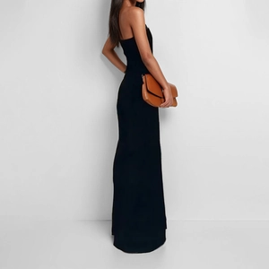 Detail of slim-fit black sleeveless evening gown with elegant floor-length drape