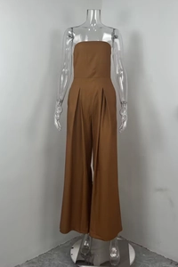 Detail of waist pleats and wide-leg draping on a brown strapless jumpsuit