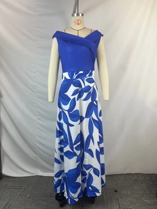 Detail of floral print maxi dress featuring blue crossover bodice and leaf pattern skirt