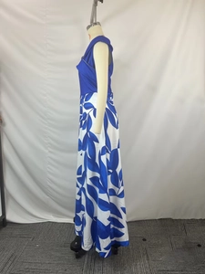 Detail of floral print maxi dress with blue leaf patterns and sleeveless bodice