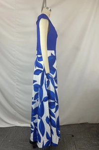Detail of elegant high-waisted floral maxi dress with blue leaf print on silk fabric