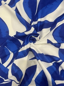 Detail of floral print fabric with royal blue leaf pattern and smooth texture
