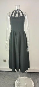 Detail of elegant black halter dress showing backless cut and refined V-shape waistline