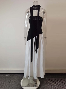 Back view of black and white maxi dress with crisscross tie-up details on open back