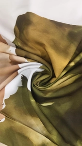 Detailed view of abstract ink print fabric with olive green and ochre watercolor texture