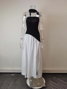 Detail of high side slit on black and white strapless maxi dress with neck scarf