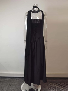 Detailed back view of black halter maxi dress showing open back with tie-up closure