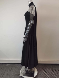 Detail of elegant black strapless maxi dress with matching neck scarf and A-line cut