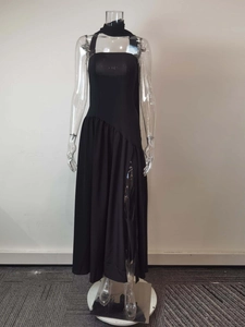Detail of elegant black halter neck maxi dress with high side slit and side ruching