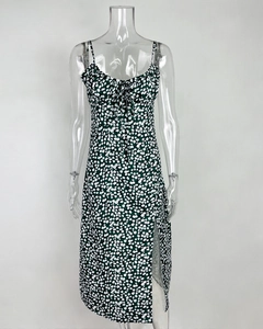 Detail of dark green floral dress featuring spaghetti straps and a decorative front tie knot