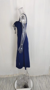 Detail of navy blue midi slip dress featuring side drawstring ruching and a slit hem