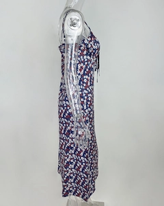 Detail of navy floral sleeveless midi dress showing vintage red and white flower patterns