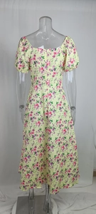 Detail view of yellow floral midi dress with back zipper and elastic puff sleeves