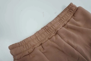 Detailed macro view of brown elastic waistband and high-quality stitching on lounge pants