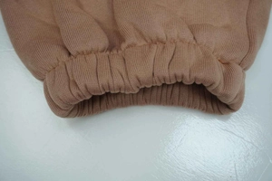 Detailed close-up of brown knit ribbed cuffs showing fabric texture and quality stitching