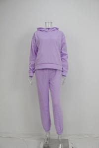 Detail view of purple hooded sweatshirt and matching joggers set in soft knitted fabric