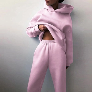 Women's pink two-piece tracksuit featuring an oversized hoodie and matching joggers