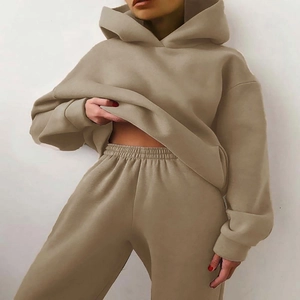Detail of khaki two-piece hoodie and jogger set showing thick cotton fabric and loose fit