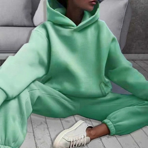Detail of mint green oversized tracksuit set showing drawstring hoodie and joggers