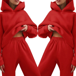 Detail of red hooded tracksuit set showing vibrant cotton fabric and elastic waistband