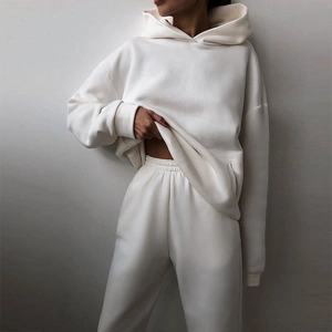 Close-up of thick cotton fabric and elastic waistband on a white casual hooded tracksuit