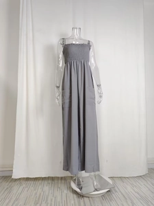 Detail of grey wide-leg jumpsuit showing ruched tube top and side patch pockets