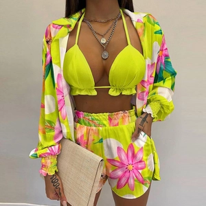 Detailed texture of fluorescent floral chiffon fabric on beach three-piece set