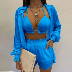 Detailed view of three-piece electric blue beach set including bikini top and shorts