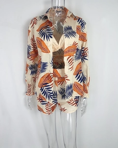 Detailed view of beach set with tropical leaf print and elastic smocked cuffs on blouse