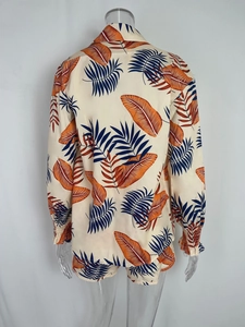 Rear view of tropical leaf print shirt with elastic cuffs and matching shorts