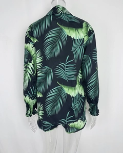 Rear view of tropical palm leaf print shirt and shorts set on transparent mannequin