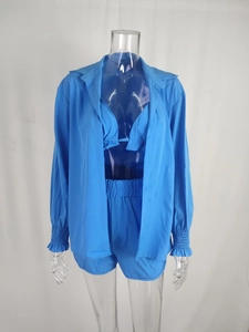 Detailed view of women's three-piece royal blue set with shirt, bikini top and shorts