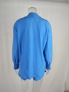 Rear view of light blue two-piece vacation set featuring long-sleeve top and shorts