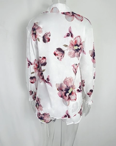 Detailed back view of satin floral shirt with elastic cuffs and ruffle edges for beachwear