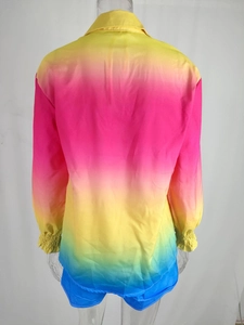 Detail of colorful gradient satin top with elastic cuffs and vibrant vertical transition