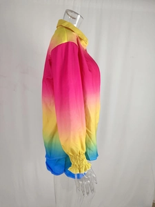 Detail of gradient rainbow shirt featuring elastic ruffled cuffs and vibrant fabric