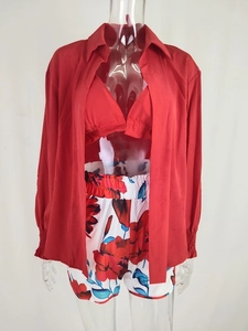 Detail view of a 3-piece beach set featuring a red shirt, bikini top and floral shorts