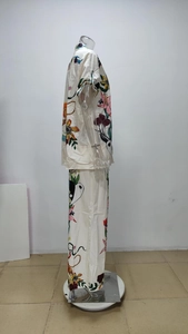 Close-up of leopard and sunflower print on satin fabric shirt and pants set