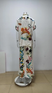 Rear view of floral print shirt and wide-leg trousers set in silky fabric
