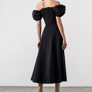 Detail view of the back showing a backless design with hidden zipper on a black midi dress