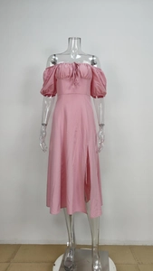Detail of pink puff sleeve dress featuring a drawstring chest tie and high side slit